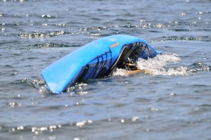 Blue kayak rolling