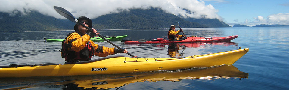 Three sea kayakers paddling on a beautiful day.